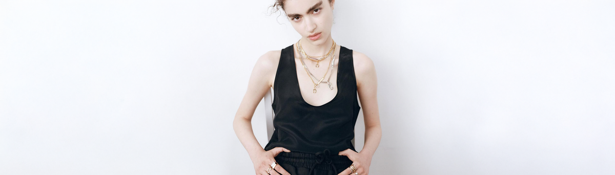 A woman in layered custom jewellery