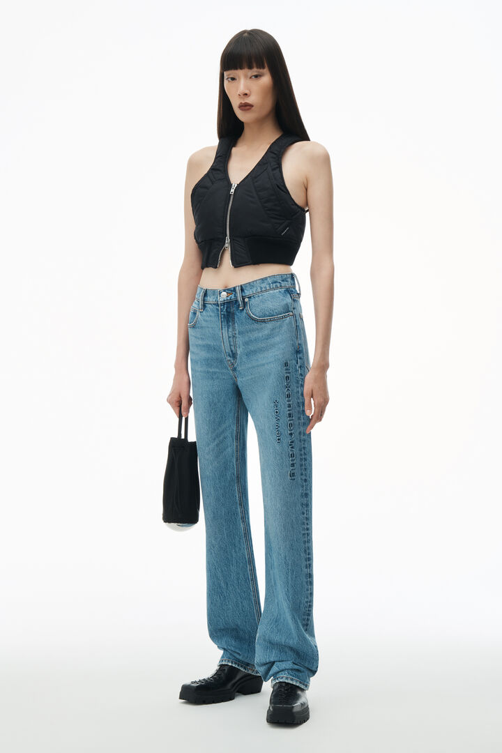 The Alexander Wang EZ Mid Rise Relaxed Straight Logo Emboss Jean in Vintage Light Indigo available at The New Trend. 