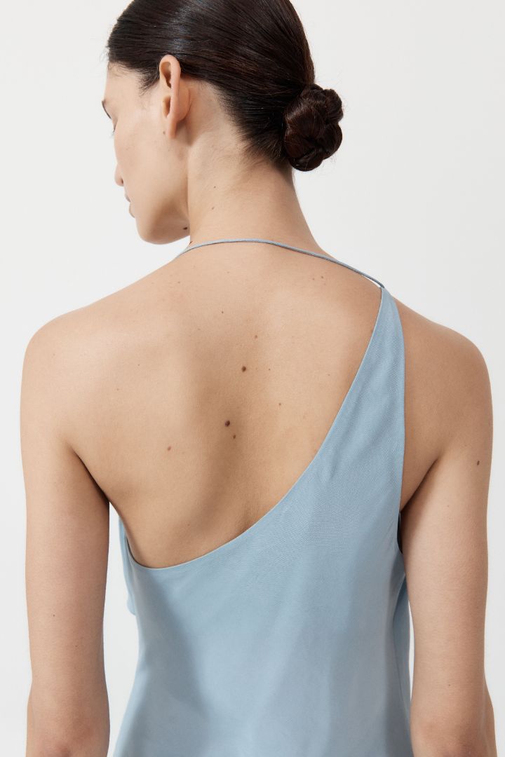 The ST. AGNI Asymmetrical Drape Dress in Stone Blue from The New Trend.