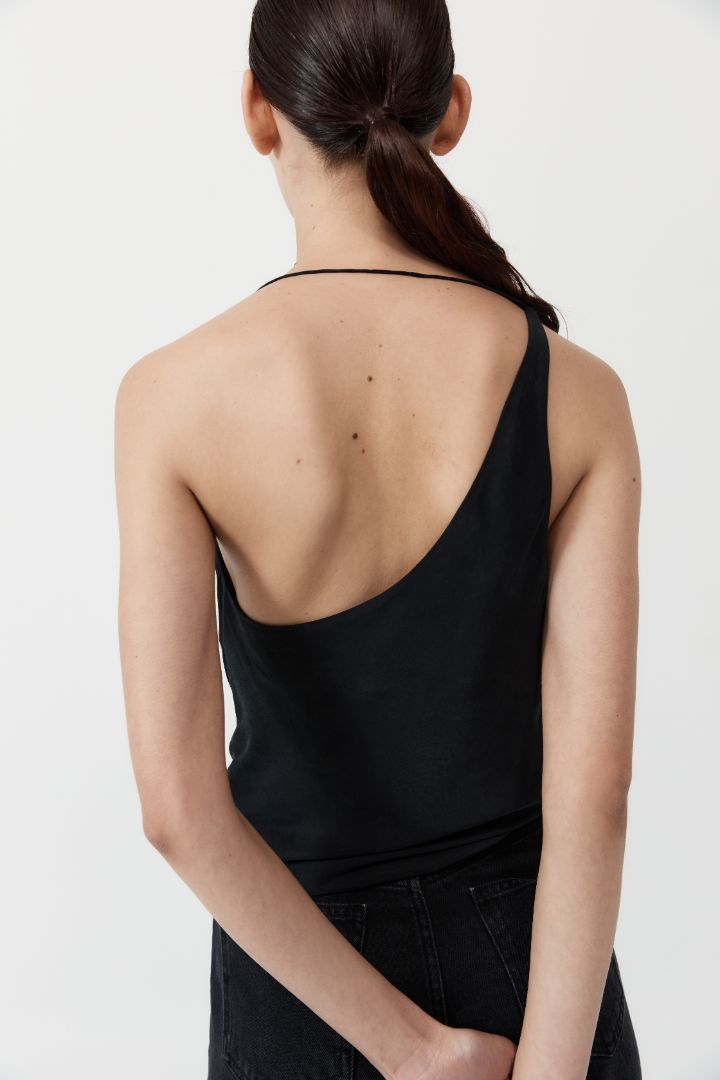 The ST. AGNI Asymmetrical Drape Top in Black from The New Trend.