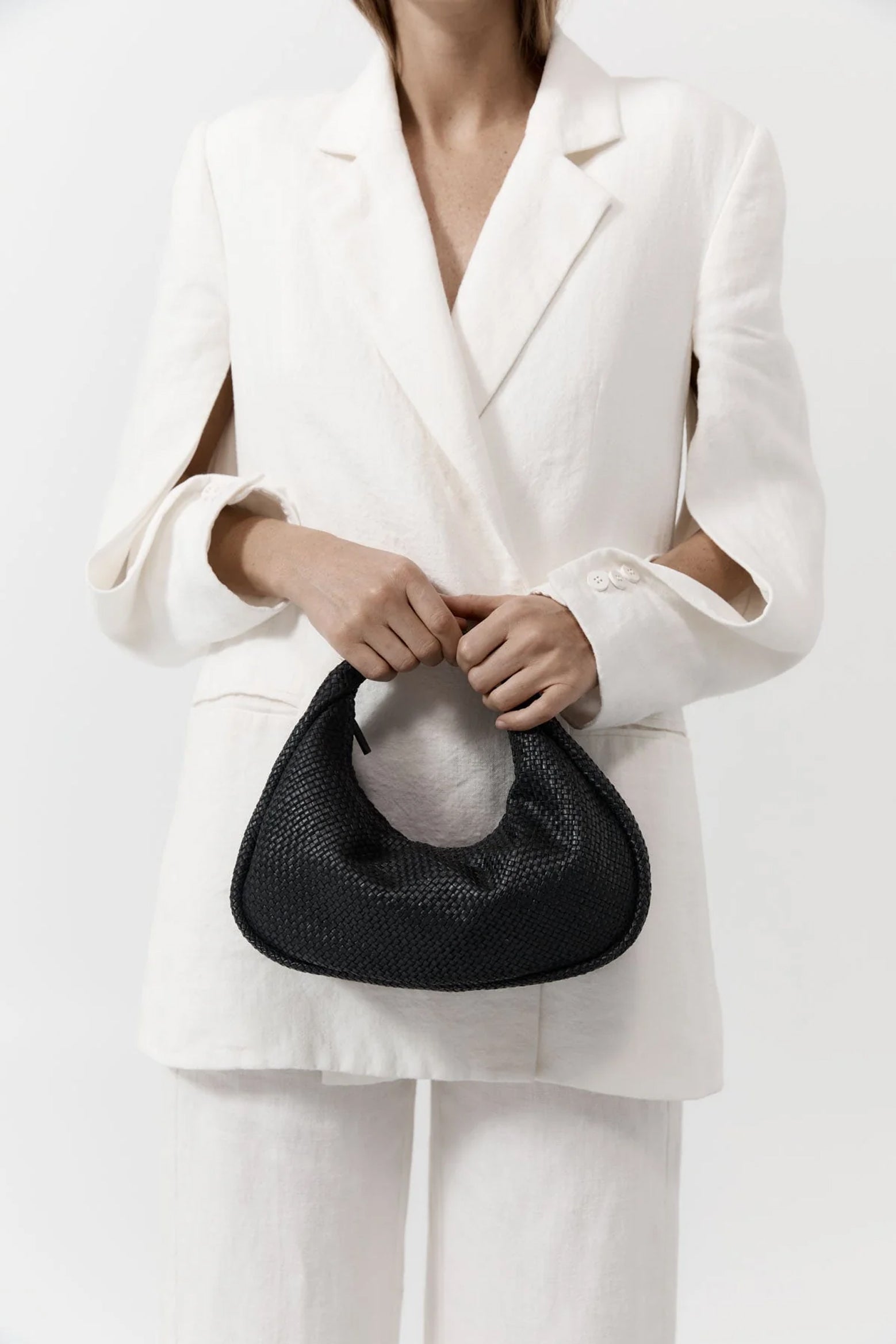 The ST. AGNI Woven Bon Bon Bag in Black from The New Trend.